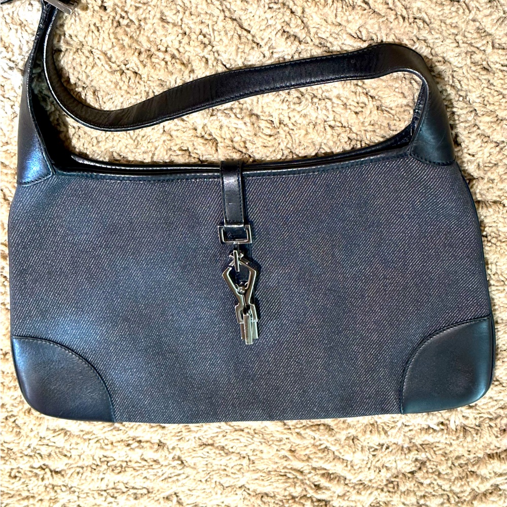 Gucci Kadensky black leather and gray denim bag with silver metal clip closure.